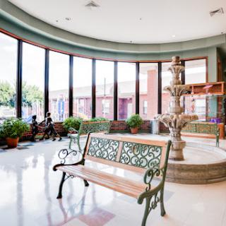 A bright and inviting lobby featuring a decorative fountain and comfortable seating.