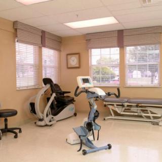 A therapy room equipped with exercise machines for rehabilitation purposes.