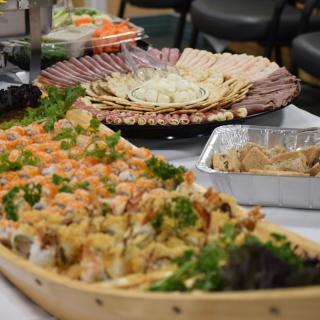 A lavish buffet setup featuring assorted sushi and seafood platters.