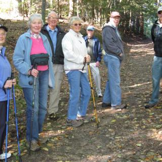 A group of people enjoying a hike in the forest.