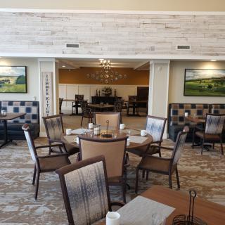 A cozy dining area with neatly arranged tables and chairs in a restaurant setting.