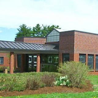 A modern brick building showcasing clean lines and thoughtful landscaping.