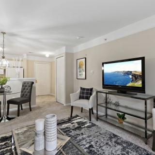 A modern open-concept living room with a dining area featuring stylish furniture and decor.
