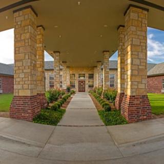 A grand building entrance with stone columns and a central walkway.
