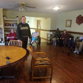 Elderly individuals in a communal area of a nursing home.