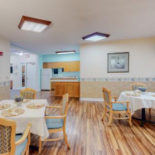 A cozy dining area featuring elegantly set tables in a residential facility.