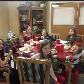 A joyful gathering of children enjoying a festive meal together.