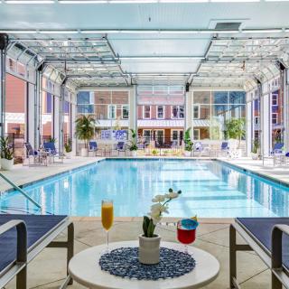 A luxurious indoor pool area with seating and refreshments, inviting relaxation and leisure.