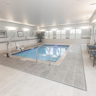 An indoor swimming pool with surrounding seating and decor.