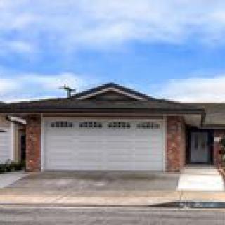 A suburban house with a double garage and driveway.