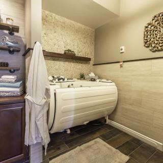 A cozy laundry room with shelves, a washing machine, and neatly stacked towels.