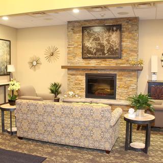 A cozy living room with a stone fireplace and modern decor.