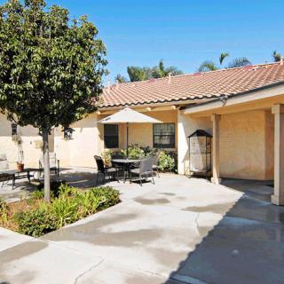 A sunny courtyard with outdoor seating and a landscaped garden.