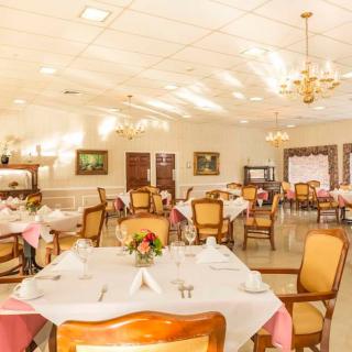 Elegant dining room setup with neatly arranged tables and warm lighting.