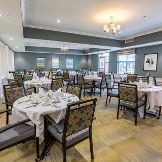 An elegant dining room with neatly arranged tables and chairs.