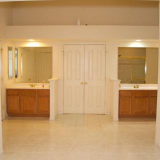 A spacious bathroom with double vanities and large mirrors.