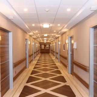 A well-lit, modern hallway featuring elegantly designed doors and a stylish floor pattern.