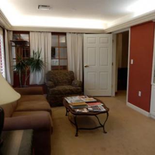 A cozy living room with a sofa, armchair, and coffee table.