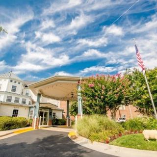 Entrance to a healthcare facility with clear skies.