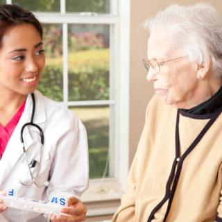 A doctor provides care and consultation to an elderly woman.