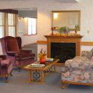 A cozy living room with classic furniture and a fireplace.