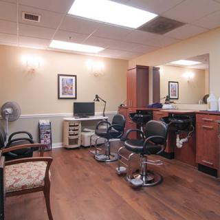 A cozy hair salon with barber chairs and mirrors.