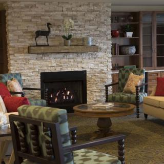 Cozy living room with a stone fireplace and comfortable seating.