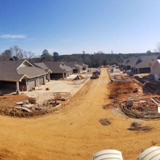 A view of a residential construction site with multiple houses under development.