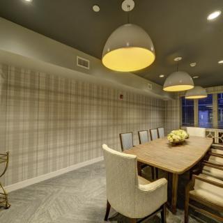 A modern dining room with elegant lighting and contemporary furniture.