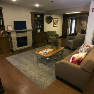 A cozy living room featuring a fireplace, television, and comfortable seating arrangements.