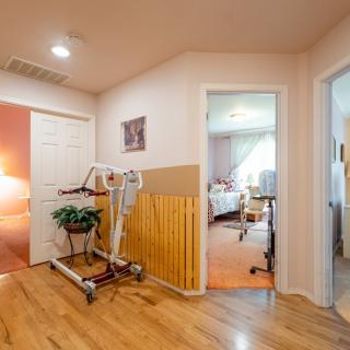 A hallway with medical equipment and adjacent bedrooms.