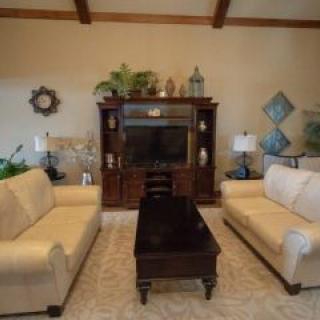 A cozy living room with two sofas, a coffee table, and an entertainment center.