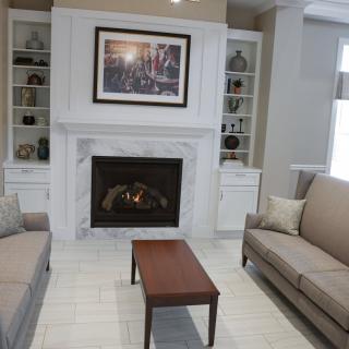 A cozy living room featuring a fireplace with built-in shelves, sofas, and a small coffee table.