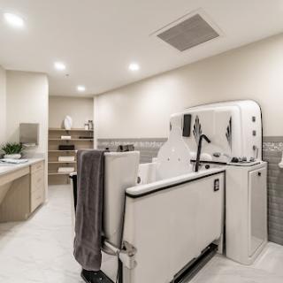 A stylish and functional modern bathroom featuring a laundry area and contemporary fixtures.