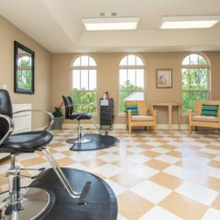 A stylish and bright hair salon featuring comfortable styling chairs and a welcoming atmosphere.