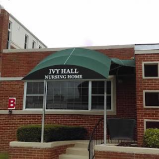 The entrance of Ivy Hall Nursing Home featuring a green canopy.