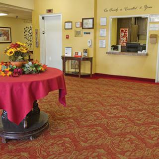 A cozy lobby with a reception desk and a decorated round table.