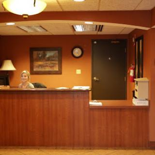 A cozy reception area with warm tones and standard office furnishings.