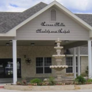 Entrance of a building with a fountain in front, labeled as a medical facility.
