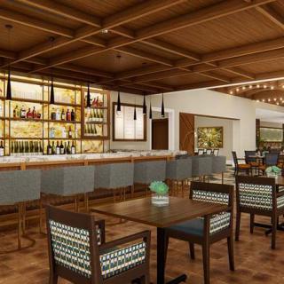 A modern bar and restaurant interior with wooden ceilings and stylish seating.