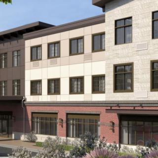A modern multi-story building with a detailed facade and multiple windows, likely a commercial property.