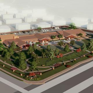 An aerial view of a landscaped urban area featuring green spaces and modern buildings.