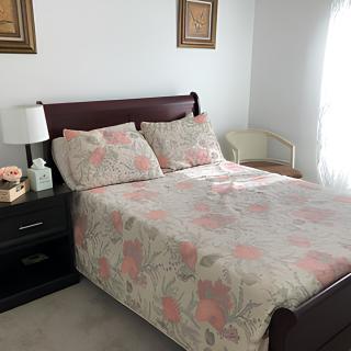 A cozy bedroom with floral bedding and elegant decor.