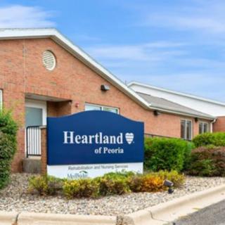 Exterior view of Heartland healthcare facility with a prominent sign and landscaped surroundings.
