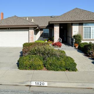 A suburban house with a well-maintained front yard and driveway.