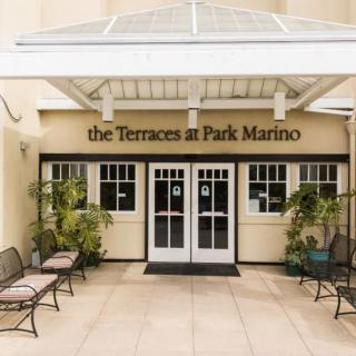 Entrance to The Terraces at Park Marino with an inviting seating area and plants.