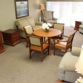 A cozy living room with comfortable seating and a round wooden table.