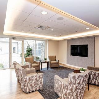 A modern living room with comfortable seating and a large television.