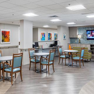 A modern lounge and dining area with bright decor and comfortable seating.