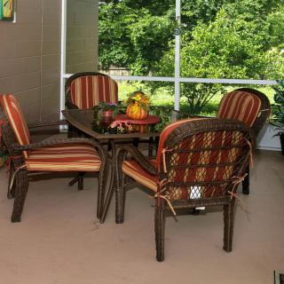 A cozy outdoor dining area with cushioned chairs and a table on a patio.